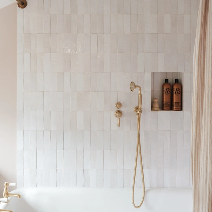 Shower wall with white rectangular zellige tiles